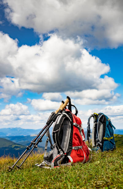 Hiking in the mountains with two backpacks in the summer.
