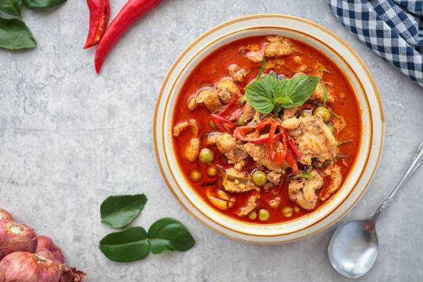 istock Panaeng pork curry,,Panaeng Curry with Pork in a ceramic bowl on cement background 2165670622