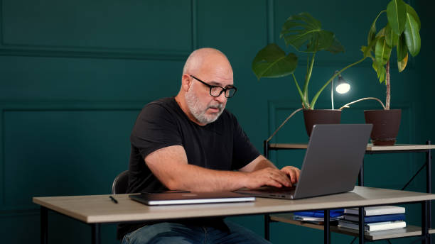 A professional male programmer brainstorms in a modern office. Perfect for themes of innovation, tech development, and collaborative problem-solving.