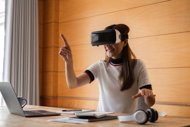 istock Young Woman Engaged in Work Using VR Glasses in a Modern Home Office Setting 2165674801