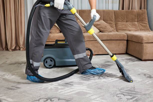 istock Expert cleaner in full protective outfit cleans carpet professionally 2165677700