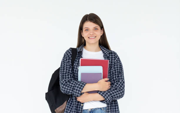 istock Caucasian girl student in blue shirt with folder, books, notebook, notepad in hands smiling isolated on white studio background, copy space 2165678641