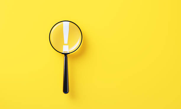 istock Black Magnifier And White Exclamation Point On Yellow Background 2165679379