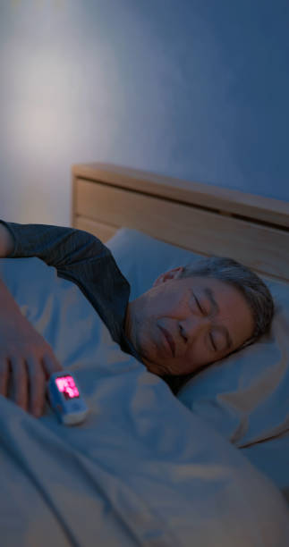 istock man sleep with pulse oximeter 2165679466