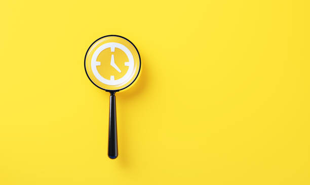 istock Black Magnifier And White Clock Symbol On Yellow Background 2165679517