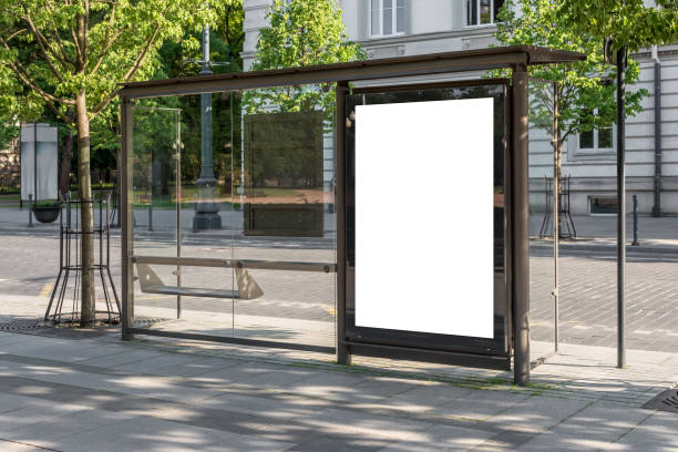 istock Blank White Bus Stop Vertical Billboard Mockup In Front Of An Empty Street 2165679566