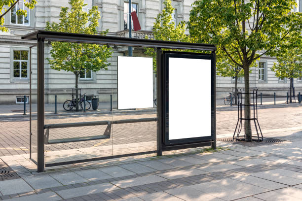 istock Blank White Bus Stop Billboard Mockup In Front Of An Empty Street 2165679579