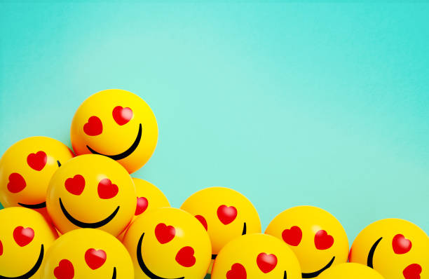 istock Yellow Spheres Textured With Love Face Emoji On Blue Background 2165680360