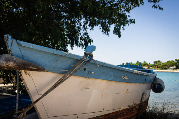 Small blue motor boat on a coast .Shot in Croatia. Adriatic sea.