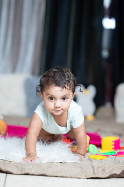 istock Baby boy 9 months old crawling on floor 2165684840