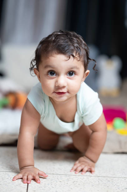 istock Happy baby crawling towards camera at home 2165684854