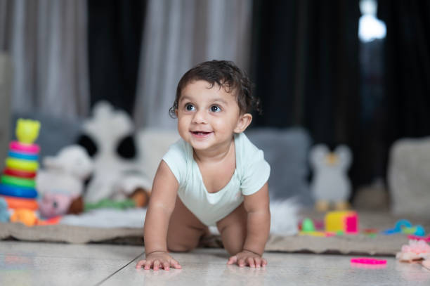 istock Happy baby crawling towards camera at home 2165684872