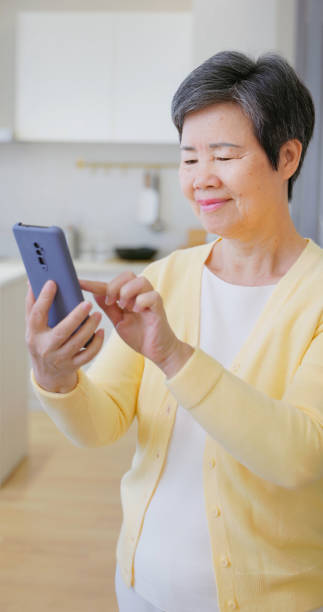 istock asian old female learn tehnology 2165687737