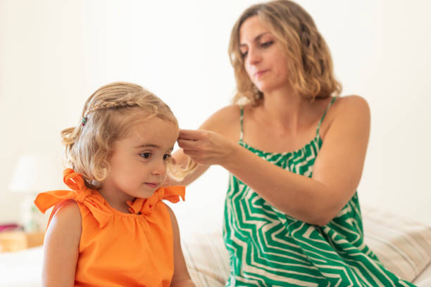 istock Mother styling daughter's hair 2165688812