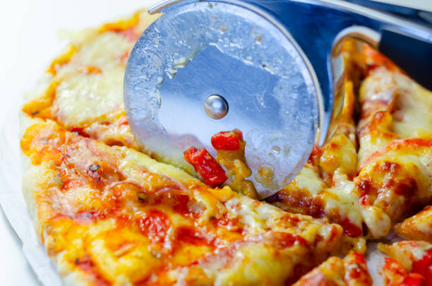 istock Cutting famous Neapolitan pizza based on buffalo mozzarella and tomatoes with a pizza cutter 2165689028