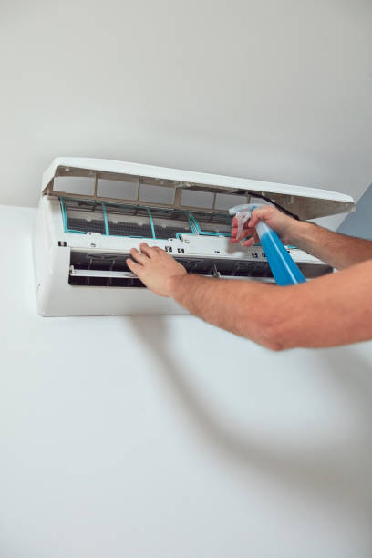 istock Man cleaning and maintaining air condition unit. 2165690367