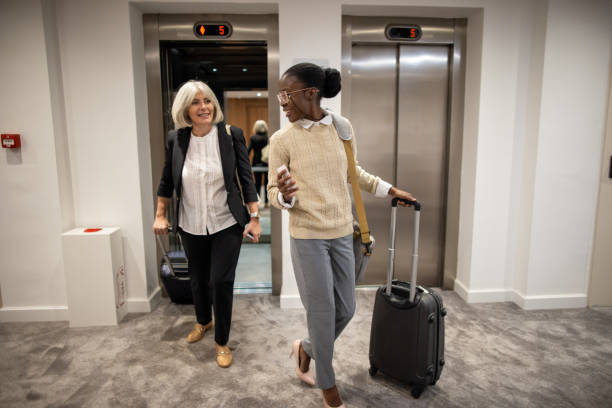istock Women walking out of the elevator 2165691674