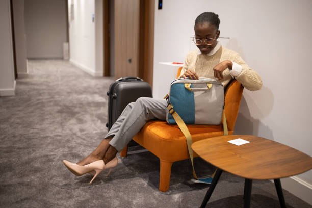 istock Woman sitting in hotel lobby 2165691849