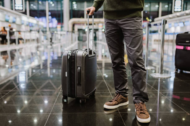 istock Man with a suitcase at the airport. 2165691875