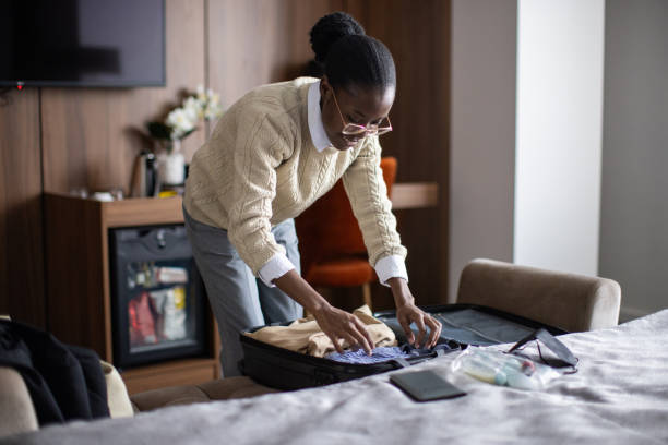 istock Woman packing in hotel room 2165693220