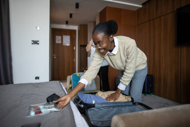istock Woman packing in hotel room 2165693350