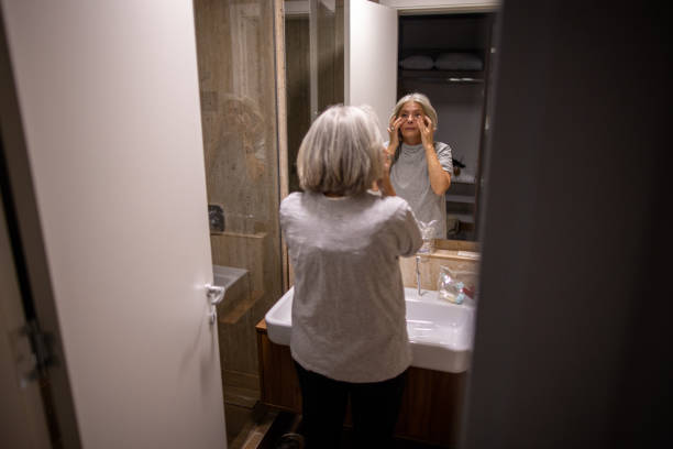 istock Mature woman in hotel bathroom 2165693904