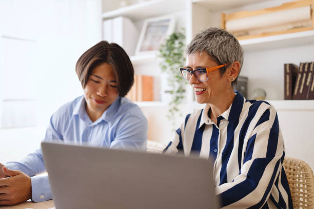 istock Multiracial coworkers share smiles after a successful discussion at work 2165697336
