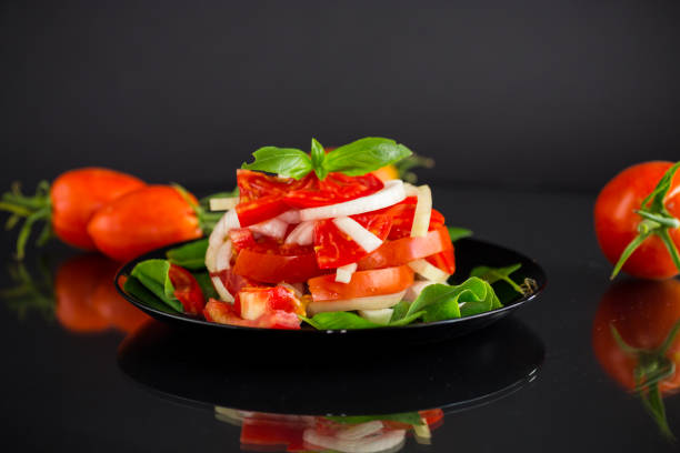 salad of fresh red tomatoes with onions.