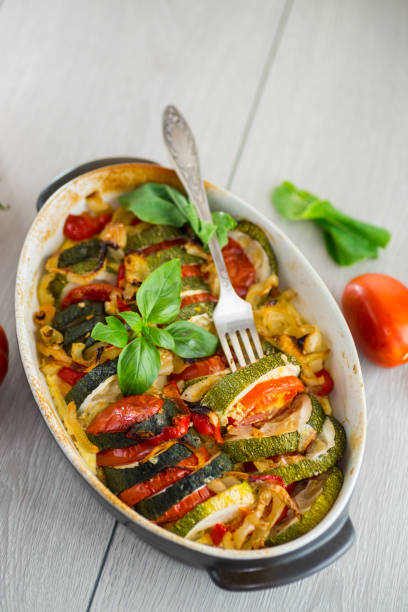 istock prepared baked zucchini and tomatoes in circles in a ceramic form, vegetable snack 2165707056
