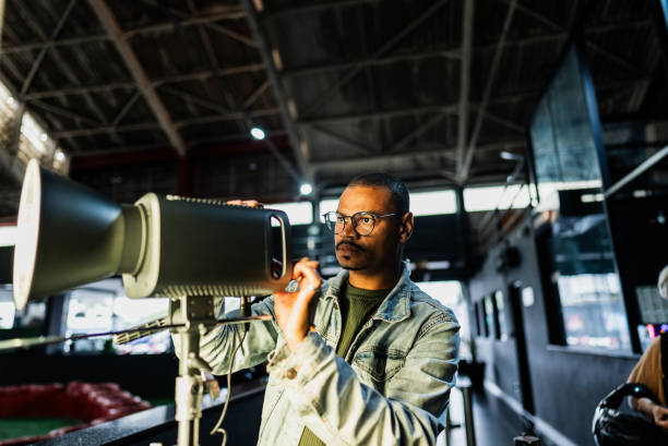 Mid adult man using lighting equipment indoors