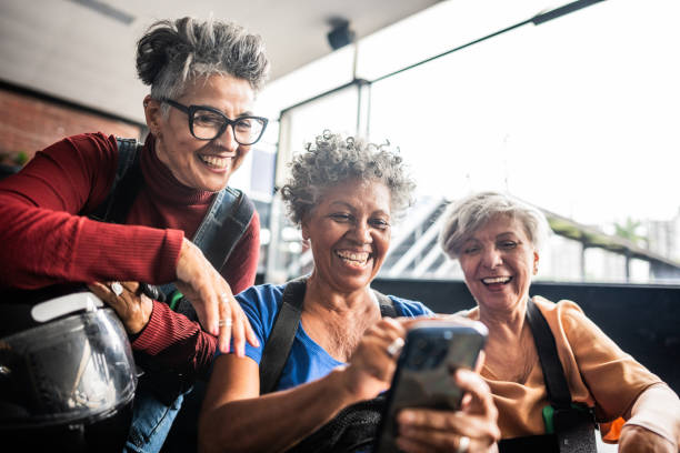 istock Female senior friends using mobile phone on karting 2165712100
