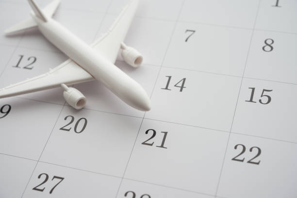 istock Airplane on white blank calendar background copy space. 2165714725