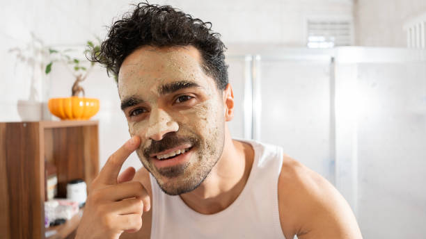 istock Happy Handsome young man making face mask in bathroom 2165715415