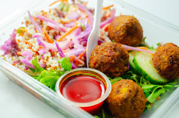 istock A salad with meatballs and a dipping sauce 2165715608