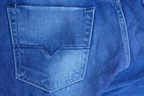 blue white cotton fabric texture with white seams and old jeans pocket