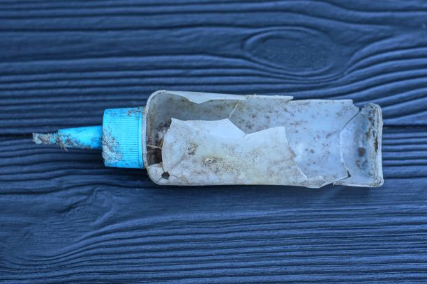 istock old dirty broken bottle lies on a black wooden table 2165716575