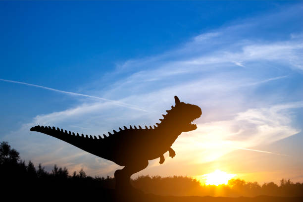 Silhouette of dinosaurs in the sunset.