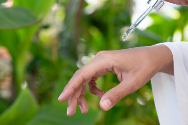 istock Woman Dripping Serum Or Essential Oil 2165717678
