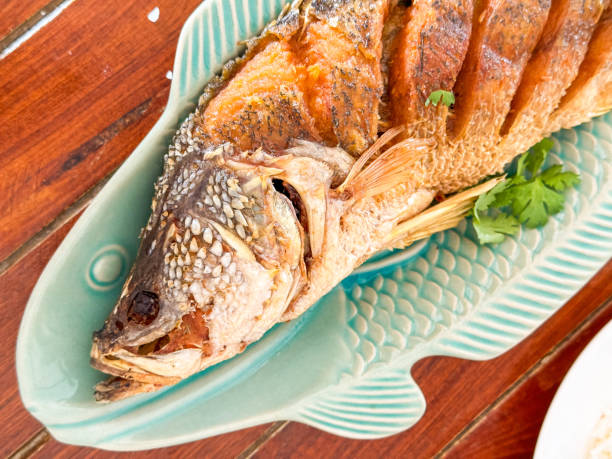 istock Fried Snapper fish on plate with sauce 2165717924