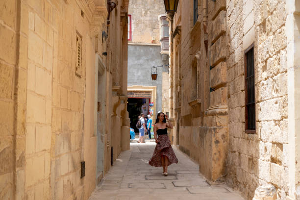 istock Woman explores old town streets, Rabat 2165718572