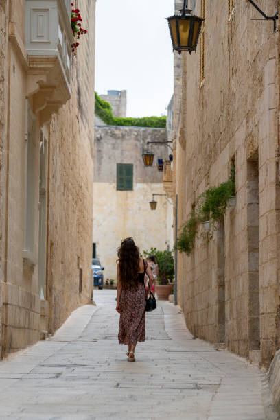 istock Woman explores old town streets, Rabat 2165719048