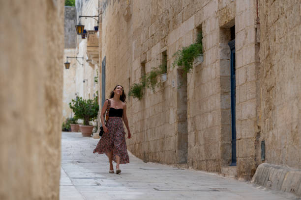 istock Woman explores old town streets, Rabat 2165719049