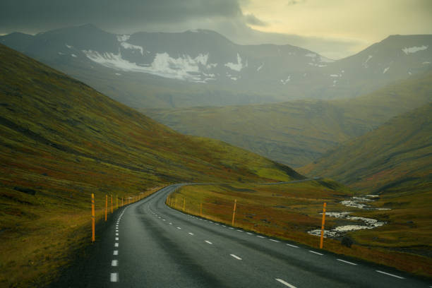 istock Empty road in northern Iceland, going through a valley surrounded by mountains 2165719078