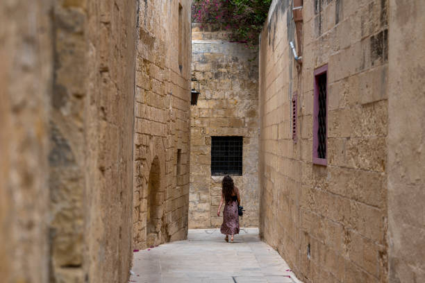 istock Woman explores old town streets, Rabat 2165719238
