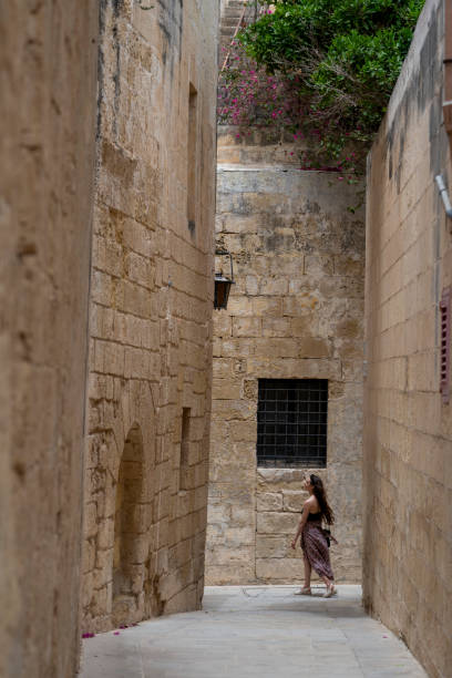 istock Woman explores old town streets, Rabat 2165719246