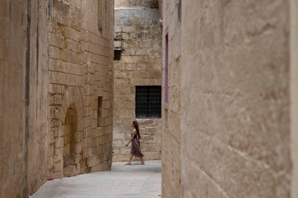 istock Woman explores old town streets, Rabat 2165719313