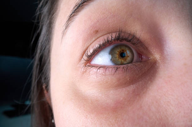 istock close up young woman's green eyes 2165722483