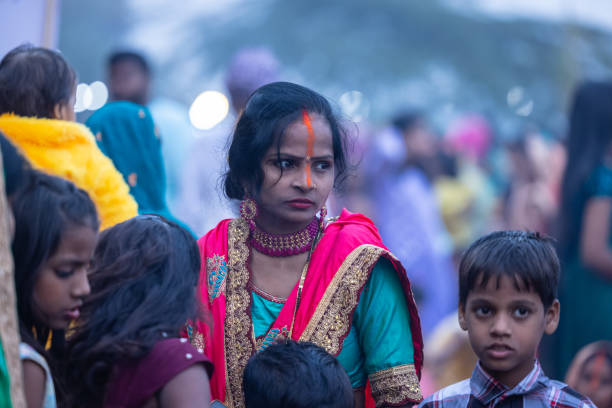 Ghaziabad, Uttar Pradesh, India - November 2023: Chhath Puja, Group of indian woman sitting on ground to perform the rituals of chhath puja in traditional ethnic clothes.