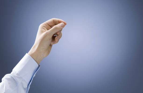 Man hand holding a card or other object, isolated on gray background