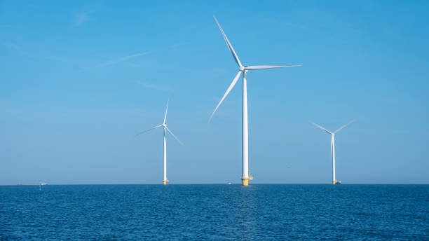 istock Breathtaking Windmill Park Soaring Above Tranquil Waters in the Netherlands Under Clear Blue Skies 2165723406